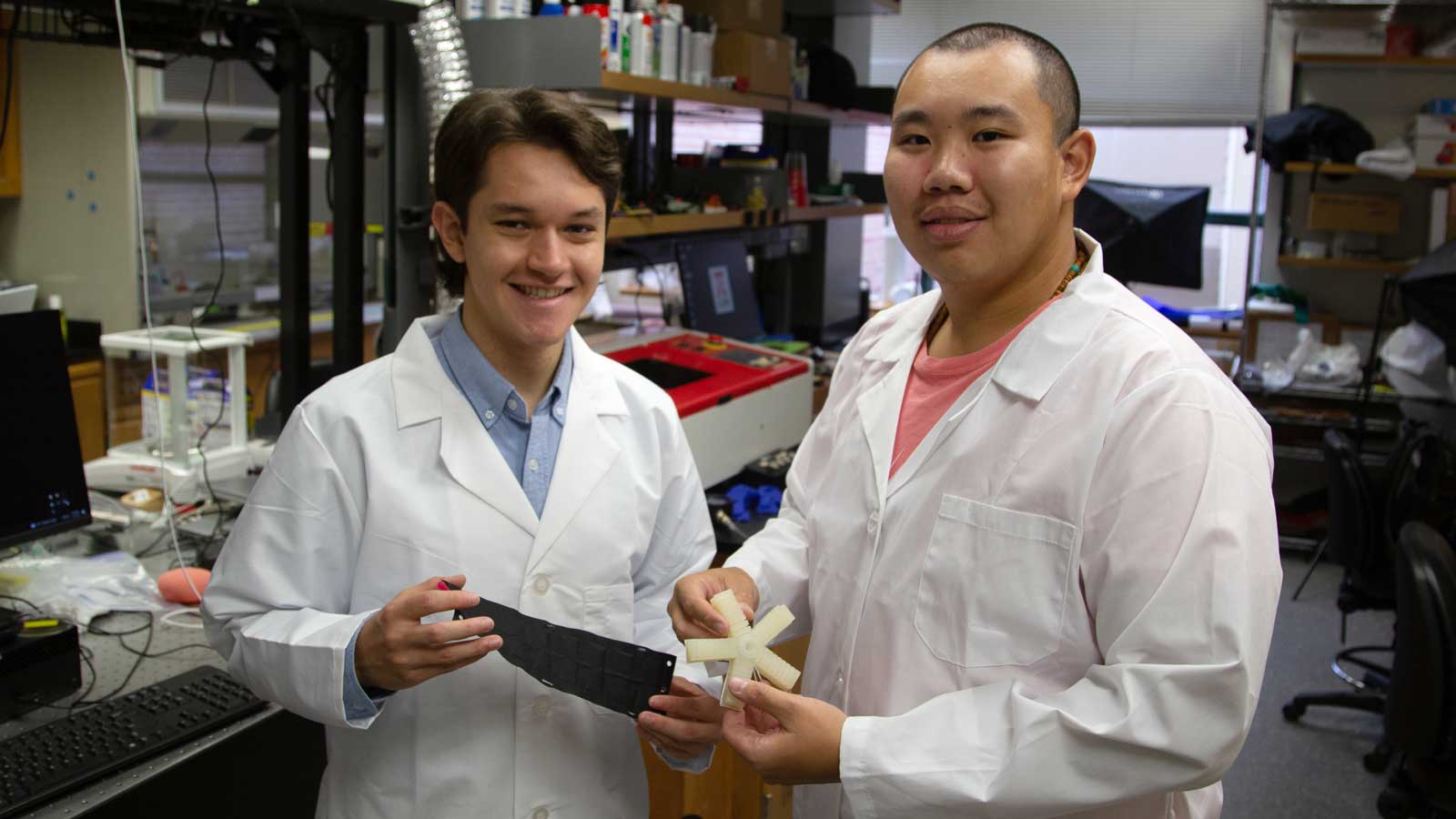 Mark Schara and Mingde “Bryan” Zeng standing in lab